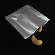 single silver foil 3 side seal pouch with two cashews sticking out