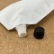 6.25" x 10.5" x 3.625" OD Matte White SpoutPak™ Stand Up Pouch with 16mm / 0.63" Fitment and Black Caps, 32 fl. oz. (250/case) - FTSSP06525CSISLW