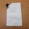 single white spoutpak with black cap laying on wood table empty