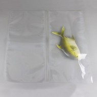 two clear vacuum seal bags with a toy fish in one