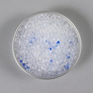 small dish with white silica beads mixed with a few blue silica desiccants