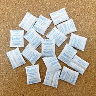 piles of .25g non indicating silica gel packets