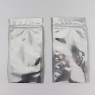 two flat silver mylar zipper closure pouches that are filled and sealed at the bottom by case