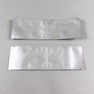 two empty silver frangible seal pouches