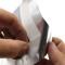 hands peeling wax paper for adhesive lip