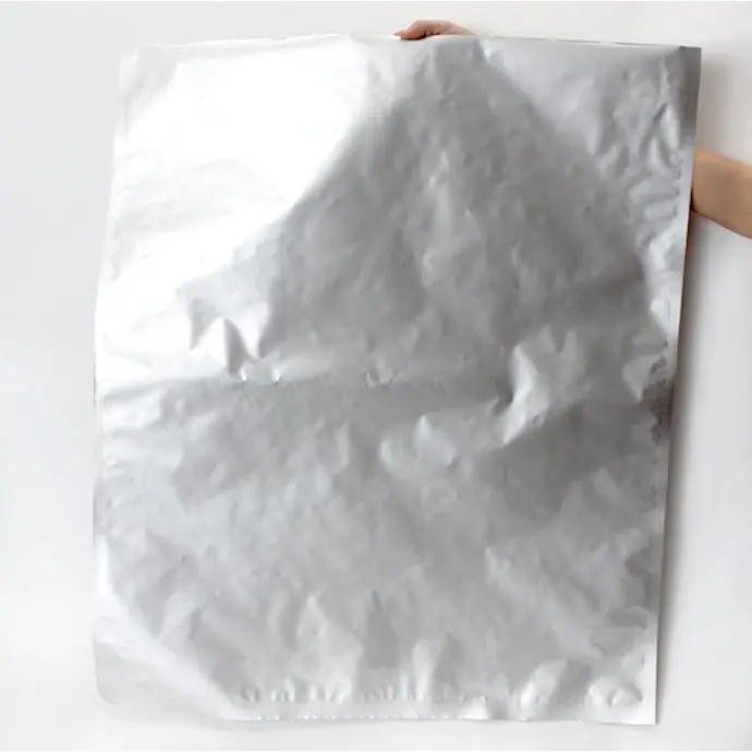 29MFS34ID 29" 34" ID Foil PET box liner bag Empty MylarFoil box liner held up by a hand