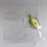 two clear vacuum seal bags with a toy fish in one