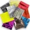 pile of yellow, gold, red, blue, orange, purple, brown, black, silver and holographic mini zipper pouches