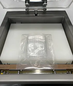 meat being sealed in a chamber vacuum