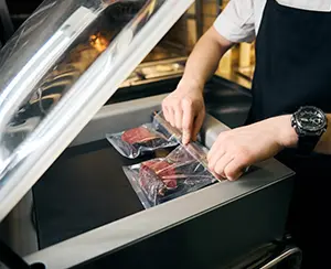 meat being sealed in a chamber vacuum
