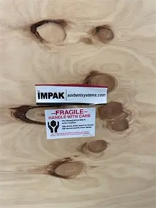Impak logo next to fragile sticker on crate