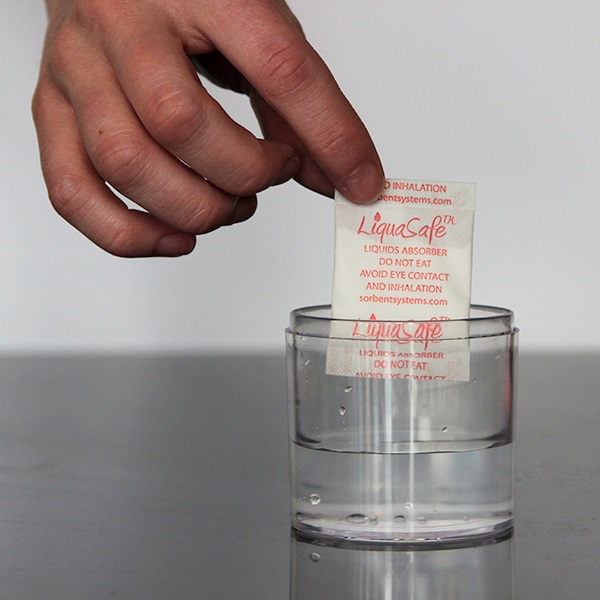 LiquaSafe being placed into a container with liquid